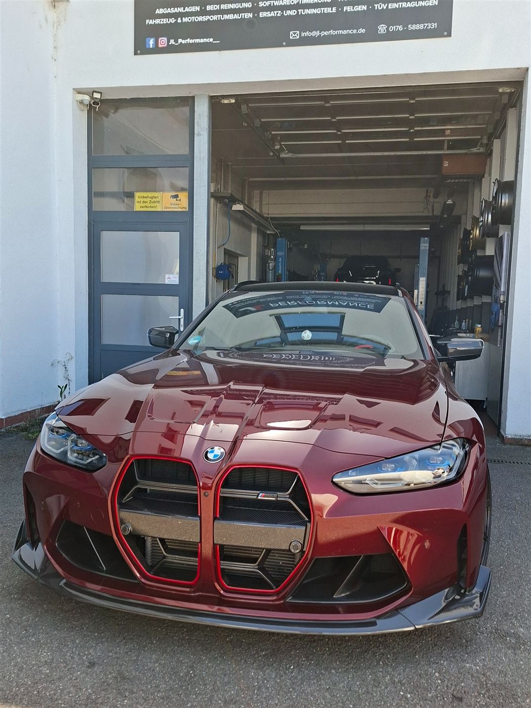 Roter BMW M3 Touring vor der Werkstatt